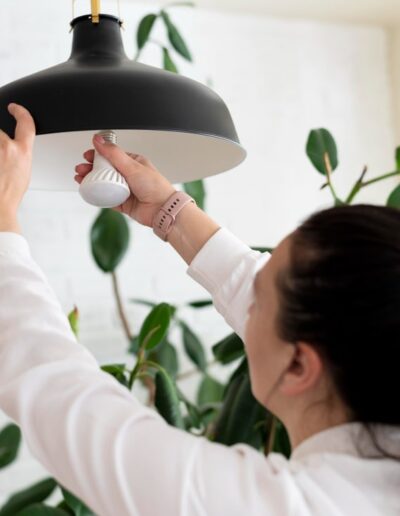 Close Up Woman Changing Lightbulb Min